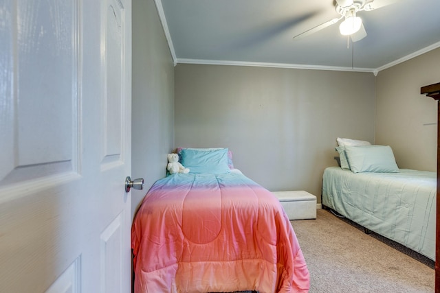 carpeted bedroom featuring ceiling fan and ornamental molding