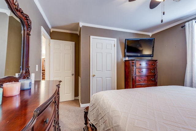 bedroom with carpet, crown molding, baseboards, and ceiling fan