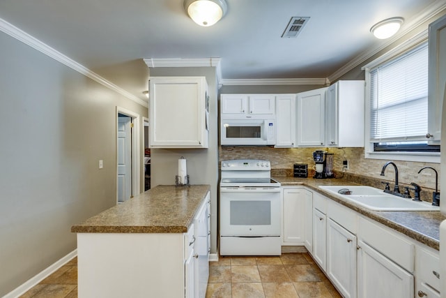 kitchen featuring white appliances, visible vents, a peninsula, white cabinetry, and a sink