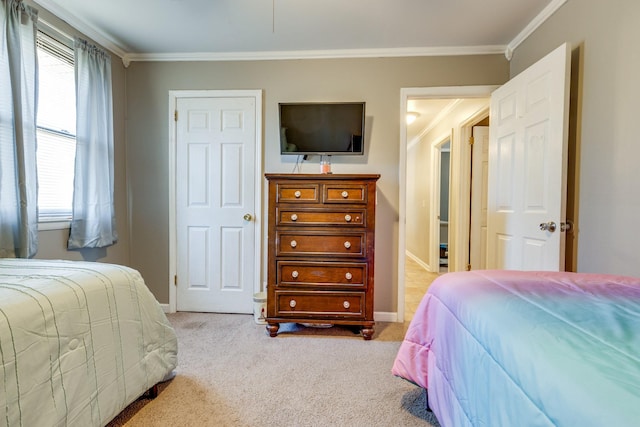 carpeted bedroom featuring baseboards and crown molding