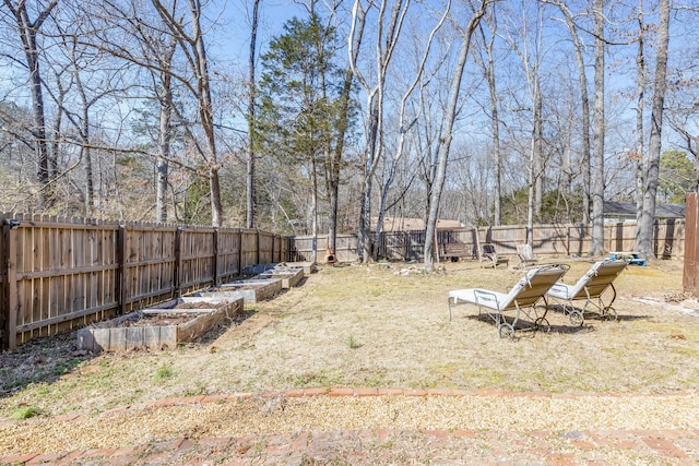 view of yard with a garden and a fenced backyard