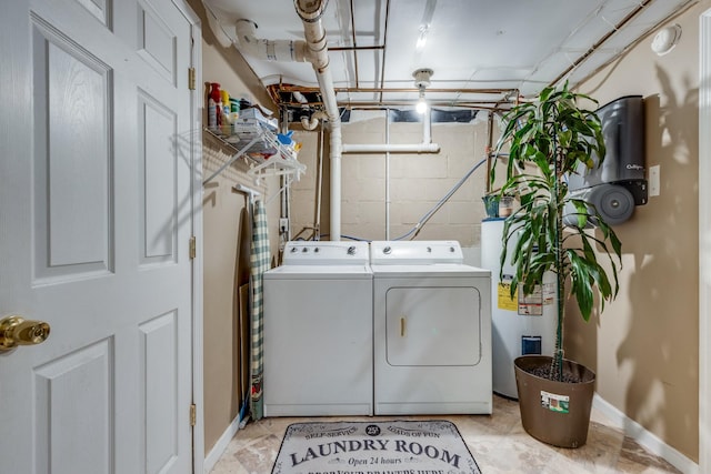 laundry room featuring laundry area, water heater, independent washer and dryer, and baseboards