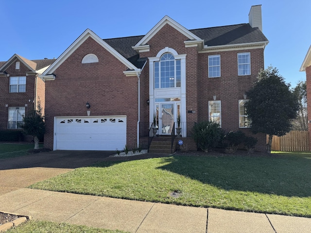 view of front of house with an attached garage, brick siding, driveway, a chimney, and a front yard