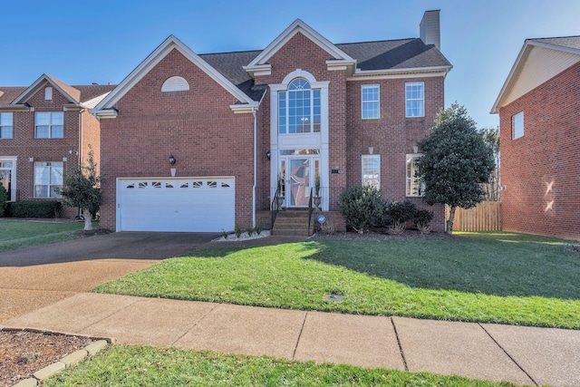 view of front of home with driveway, a chimney, an attached garage, a front lawn, and brick siding