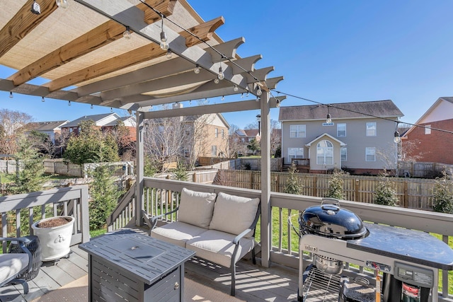 deck featuring grilling area, fence, an outdoor living space, and a pergola