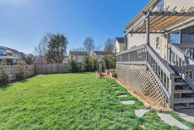 view of yard with a fenced backyard, a wooden deck, and a pergola