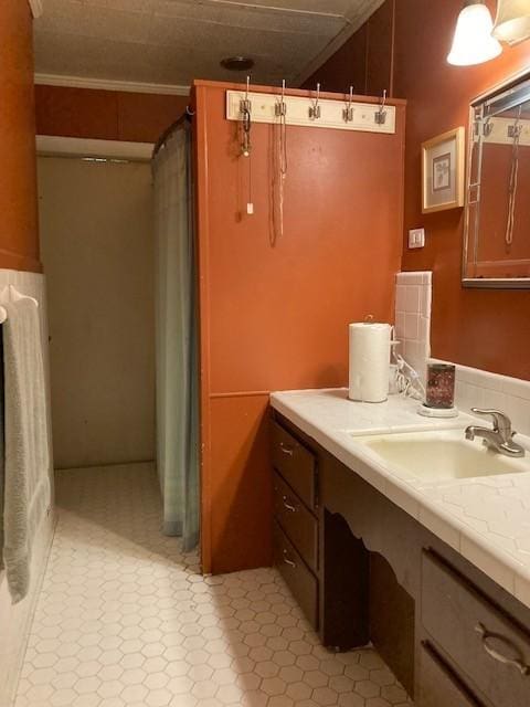 bathroom with crown molding and vanity