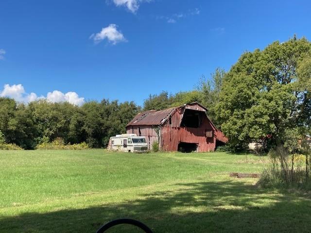 view of yard with an outdoor structure and a barn