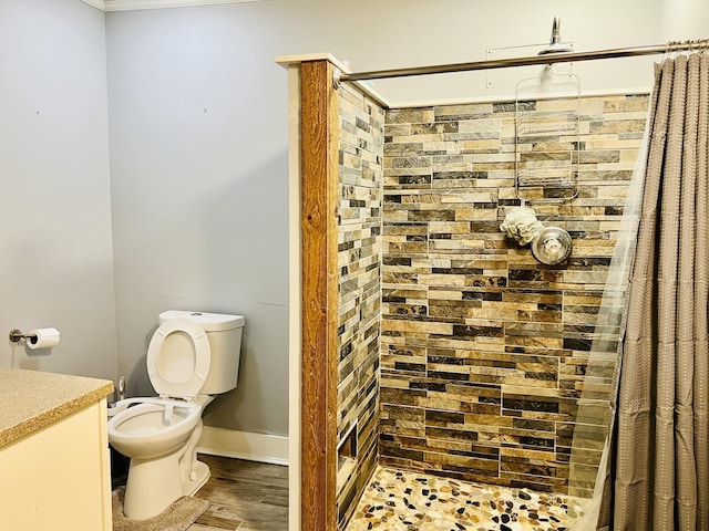 full bath featuring wood finished floors, a tile shower, and toilet