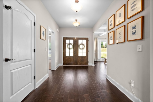 entrance foyer with dark wood-type flooring, french doors, and baseboards