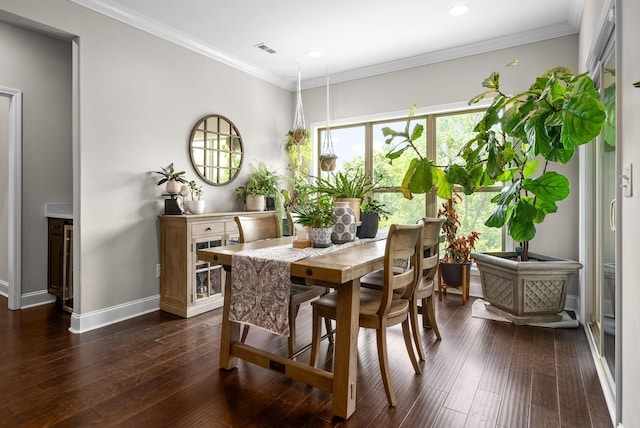 dining room with visible vents, ornamental molding, dark wood finished floors, and baseboards