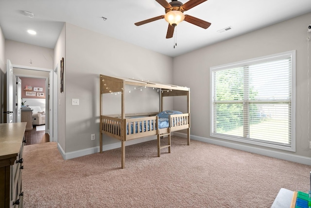 carpeted bedroom featuring visible vents and baseboards