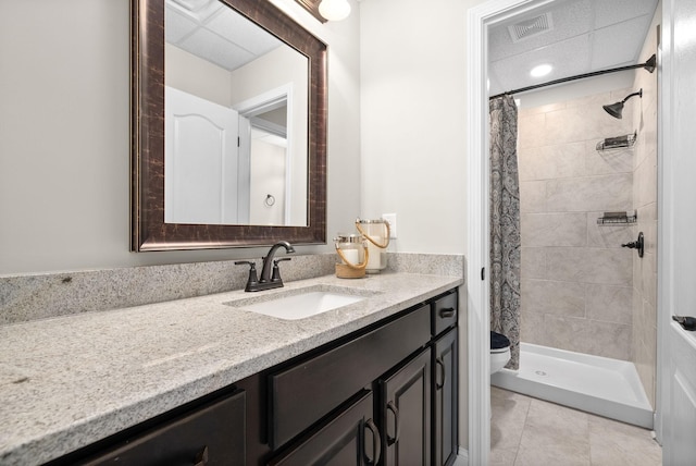 bathroom with toilet, a stall shower, tile patterned flooring, and vanity