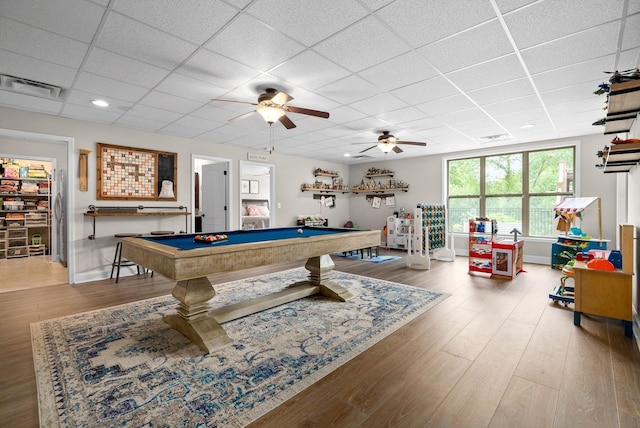 game room featuring a paneled ceiling, visible vents, and wood finished floors