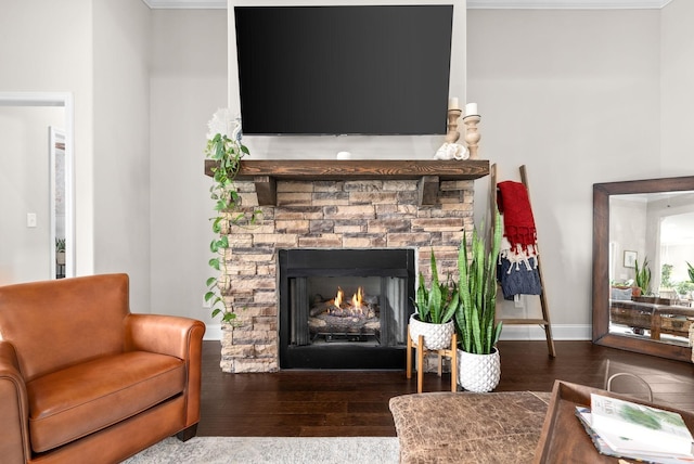 sitting room with a fireplace, wood finished floors, and baseboards