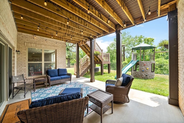 view of patio with stairway, a playground, fence, and an outdoor living space