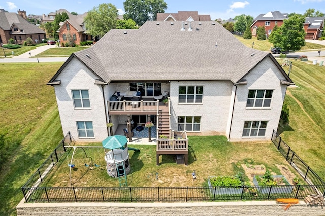 rear view of property featuring a patio, a lawn, stairway, a deck, and a fenced backyard