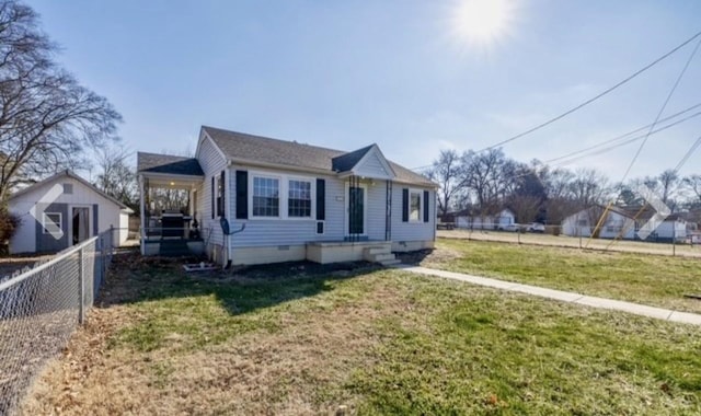 bungalow-style home featuring crawl space, a front yard, and fence