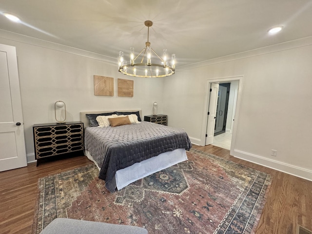 bedroom with ornamental molding, a notable chandelier, baseboards, and wood finished floors