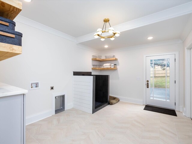 unfurnished living room with ornamental molding, a notable chandelier, and baseboards