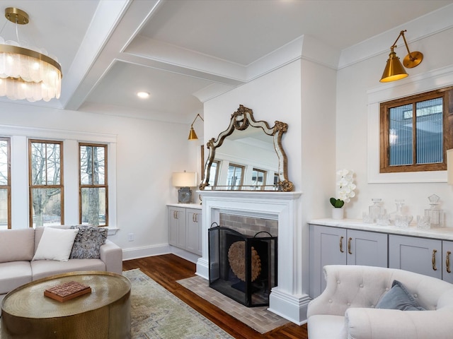 living room featuring baseboards, coffered ceiling, dark wood-style floors, beamed ceiling, and a fireplace