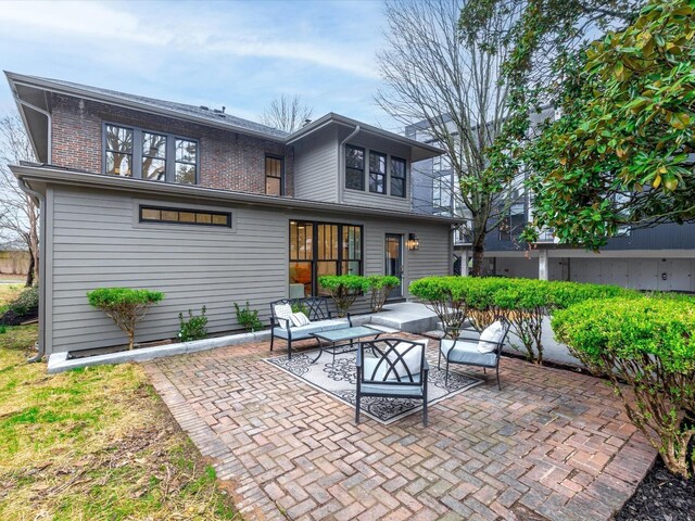 back of property featuring a patio, brick siding, and outdoor lounge area