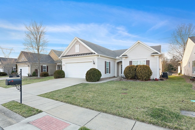 view of front of house with a front yard, cooling unit, driveway, and an attached garage