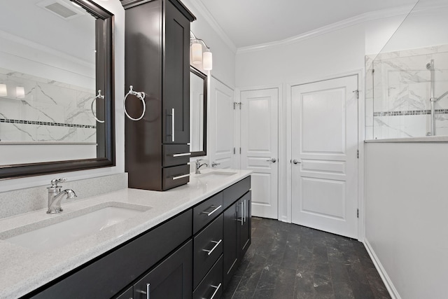 bathroom with crown molding, a marble finish shower, visible vents, and a sink