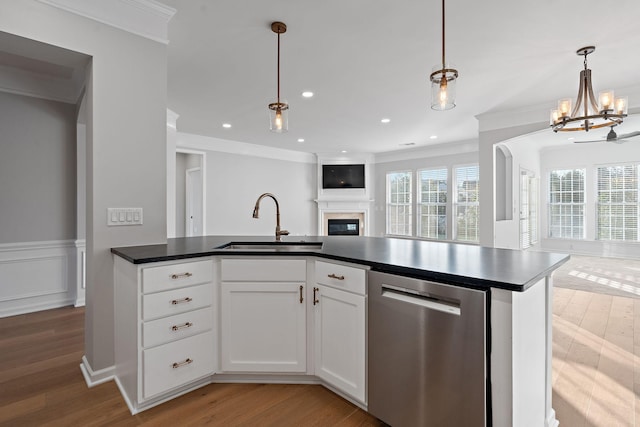 kitchen with a sink, light wood-style floors, open floor plan, and dishwasher