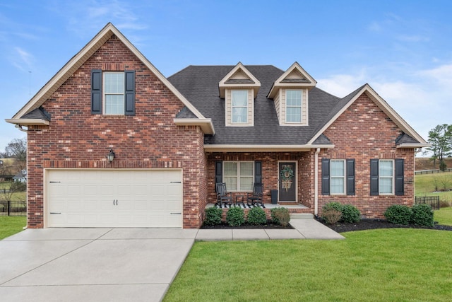 view of front of property with driveway, a porch, a front yard, and brick siding