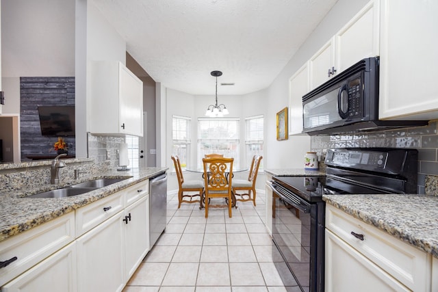 kitchen with light tile patterned floors, baseboards, a sink, black appliances, and backsplash