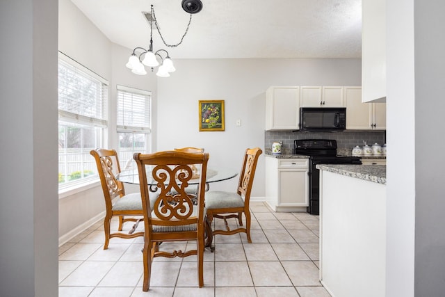 dining room with light tile patterned floors, baseboards, and a notable chandelier