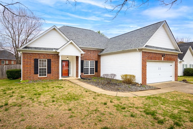 traditional-style home with a garage, concrete driveway, and brick siding