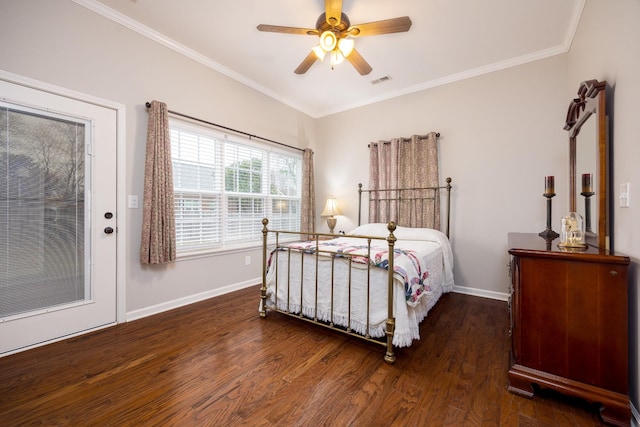 bedroom with ornamental molding, visible vents, baseboards, and wood finished floors