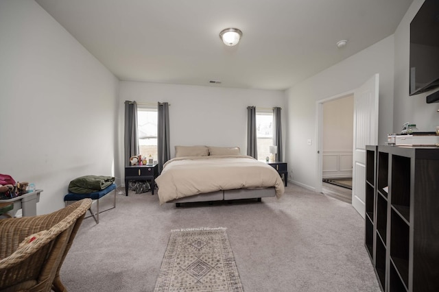 bedroom with carpet, visible vents, and baseboards