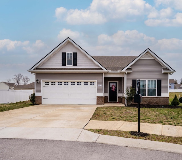 view of front of home featuring fence, concrete driveway, and brick siding