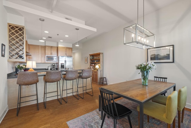 dining area with dark wood-style floors, recessed lighting, visible vents, and baseboards