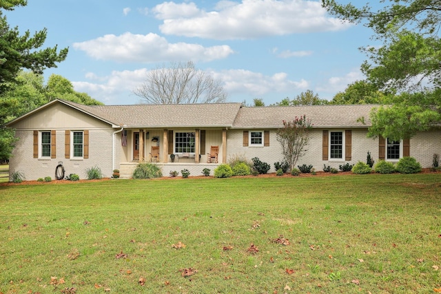 single story home featuring brick siding and a front yard