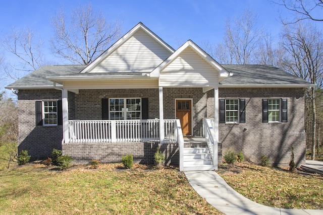 bungalow-style house with covered porch, brick siding, and a front lawn