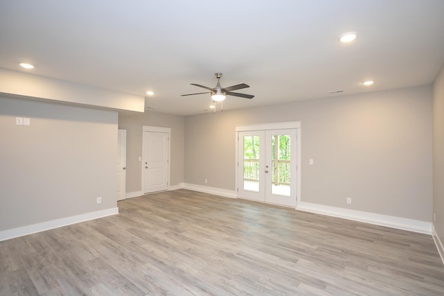 spare room with recessed lighting, light wood-style flooring, baseboards, and french doors