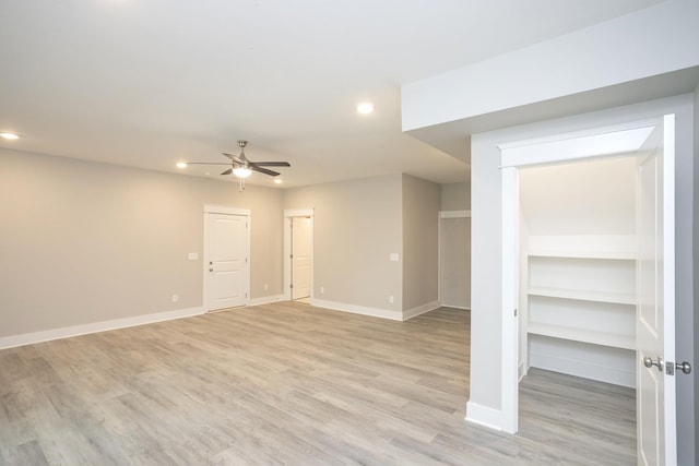 spare room featuring light wood finished floors, baseboards, and recessed lighting