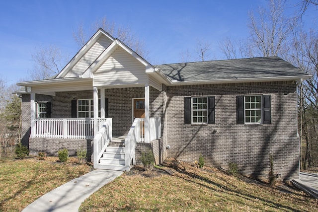 view of front of property with covered porch and brick siding