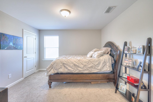 bedroom with carpet floors, baseboards, and visible vents