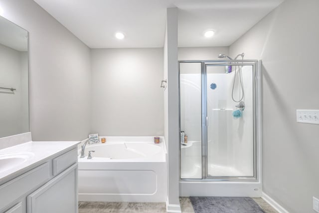 full bathroom with baseboards, a shower stall, vanity, and a bath