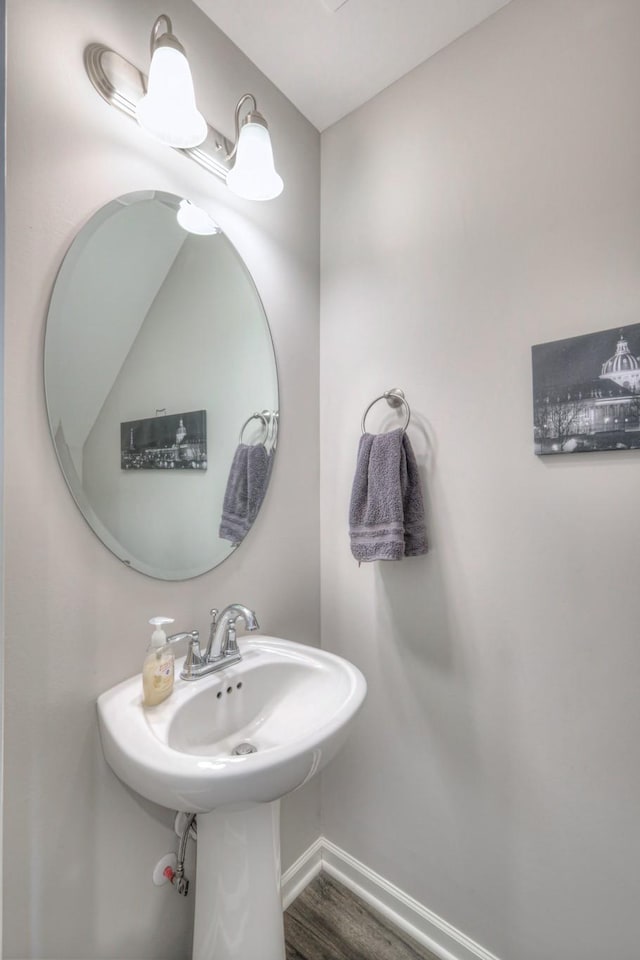 bathroom featuring wood finished floors and baseboards