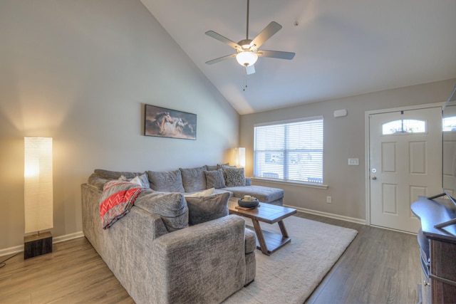 living room with high vaulted ceiling, a ceiling fan, baseboards, and wood finished floors