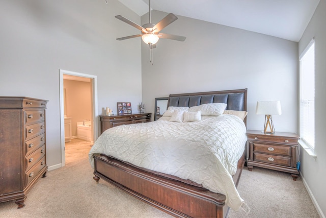 bedroom with light carpet, vaulted ceiling, baseboards, and ensuite bathroom