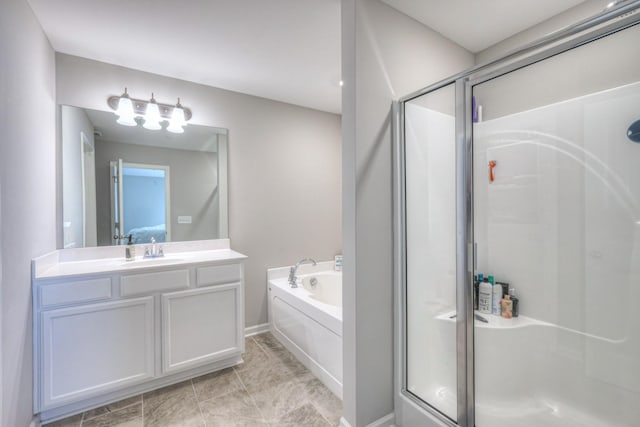 ensuite bathroom featuring a stall shower, a garden tub, connected bathroom, and vanity