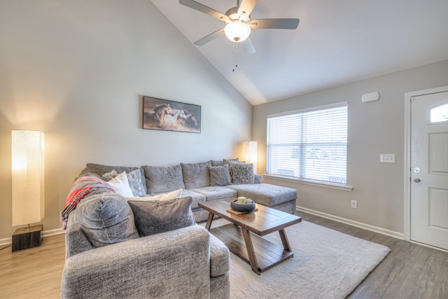 living room with a ceiling fan, a healthy amount of sunlight, baseboards, and wood finished floors