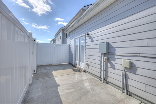 view of patio with fence and a gate